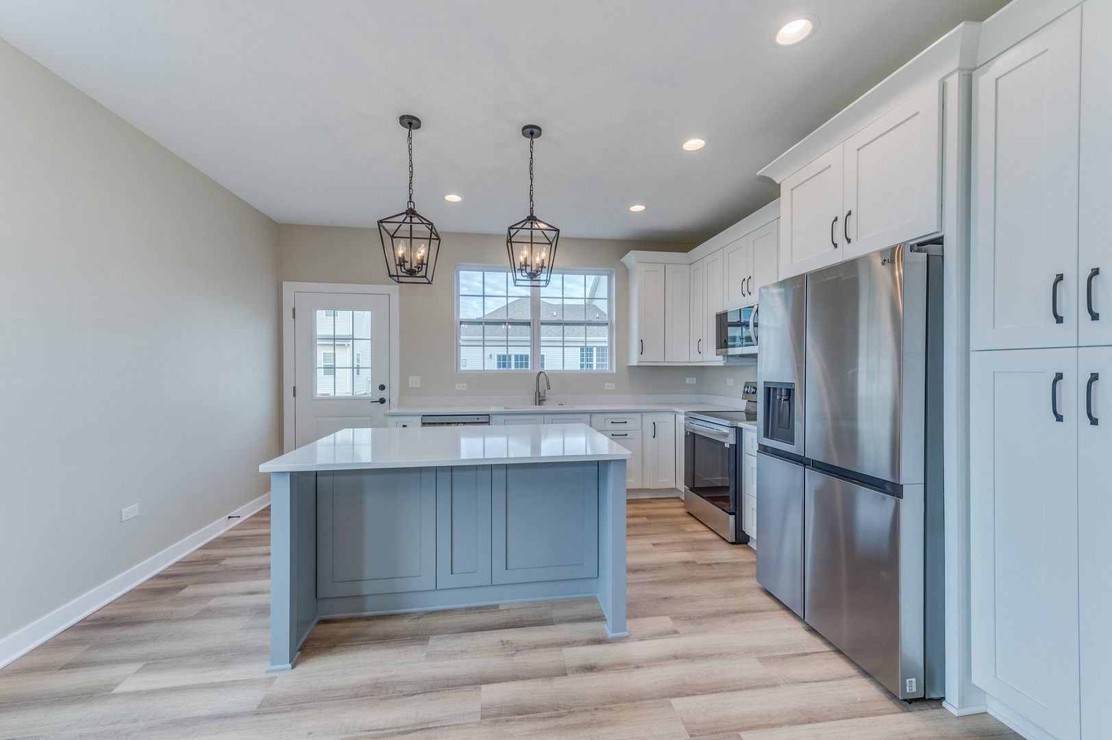 1104 Freedom Road Elburn, IL 60119 - Photo 7 of 24 a kitchen with refrigerator cabinets and wooden floor