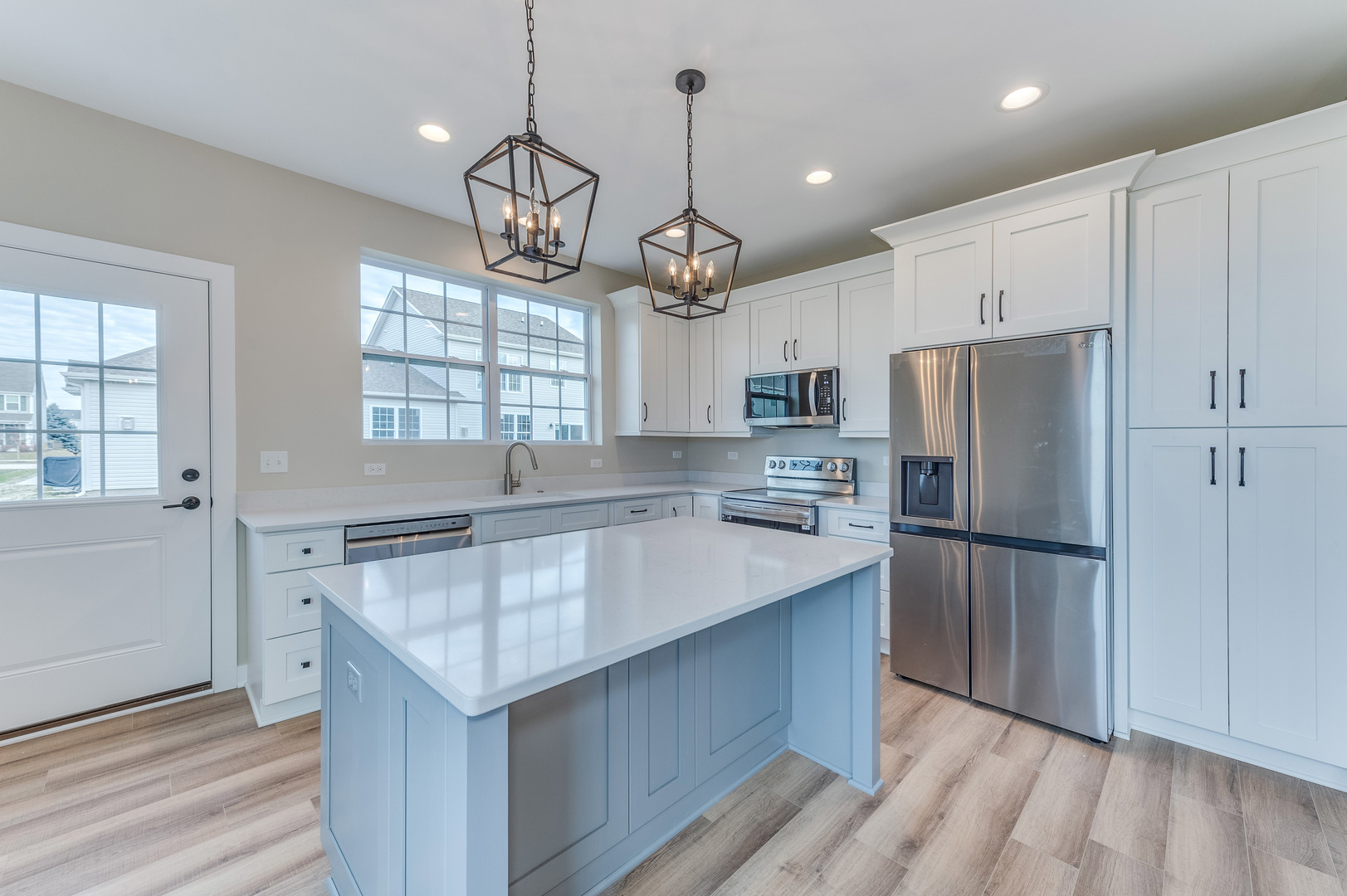 1104 Freedom Road Elburn, IL 60119 - Photo 8 of 24 a kitchen with granite countertop a refrigerator a sink dishwasher a stove and white cabinets with wooden floor