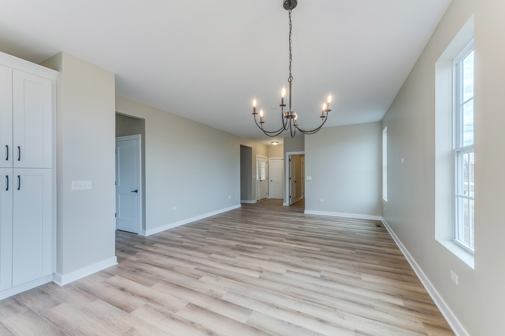 1104 Freedom Road Elburn, IL 60119 - Photo 10 of 24 a view of a livingroom with a chandelier wooden floor and window