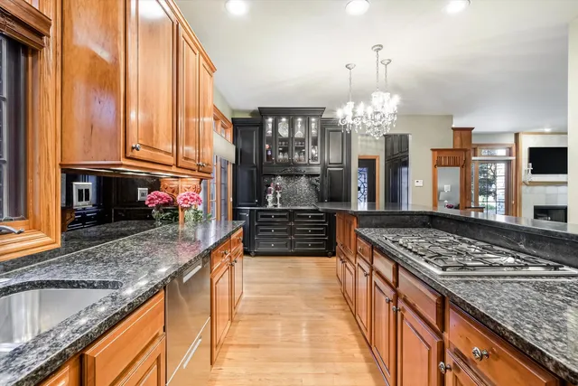 a kitchen with stainless steel appliances granite countertop a stove and cabinets