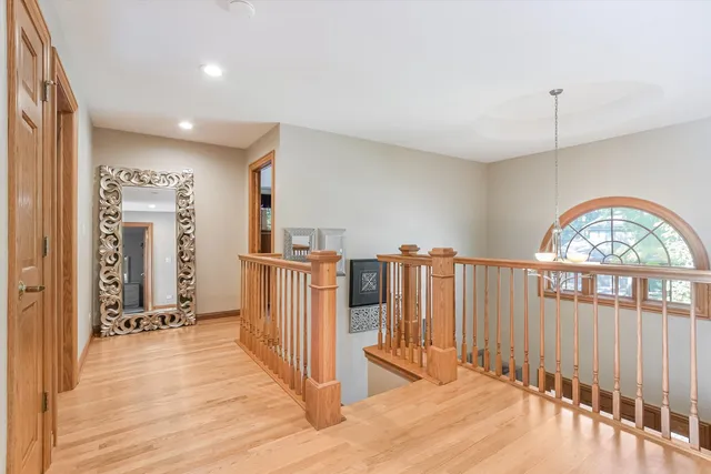 a spacious bedroom with a bed a couch and dresser