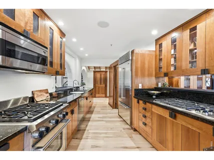 a kitchen with stainless steel appliances a stove sink and cabinets