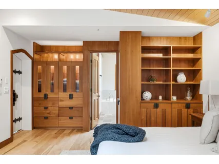 a view of bedroom with a large bed and cabinet