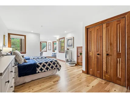 a bed room with a bed and a large window
