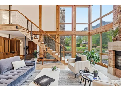 a living room with furniture and a floor to ceiling windows