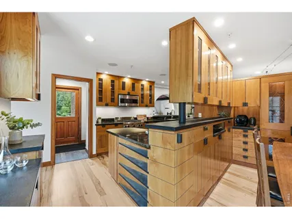 a open kitchen with stainless steel appliances granite countertop a stove and cabinets