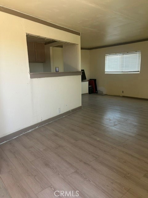 35057 Birch Road Barstow, CA 92311 - Photo 8 of 15 an empty room with wooden floor and windows