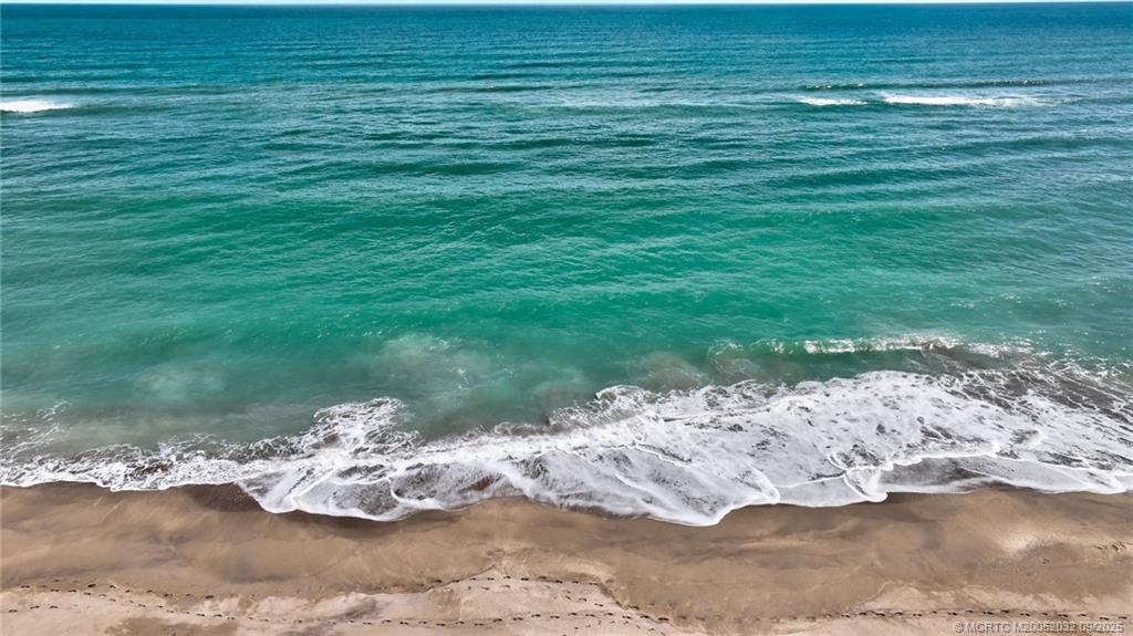 2001 Southeast Sailfish Point Boulevard, Unit 303 Stuart, FL 34996 - Photo 14 of 63 a view of a lake with a yard