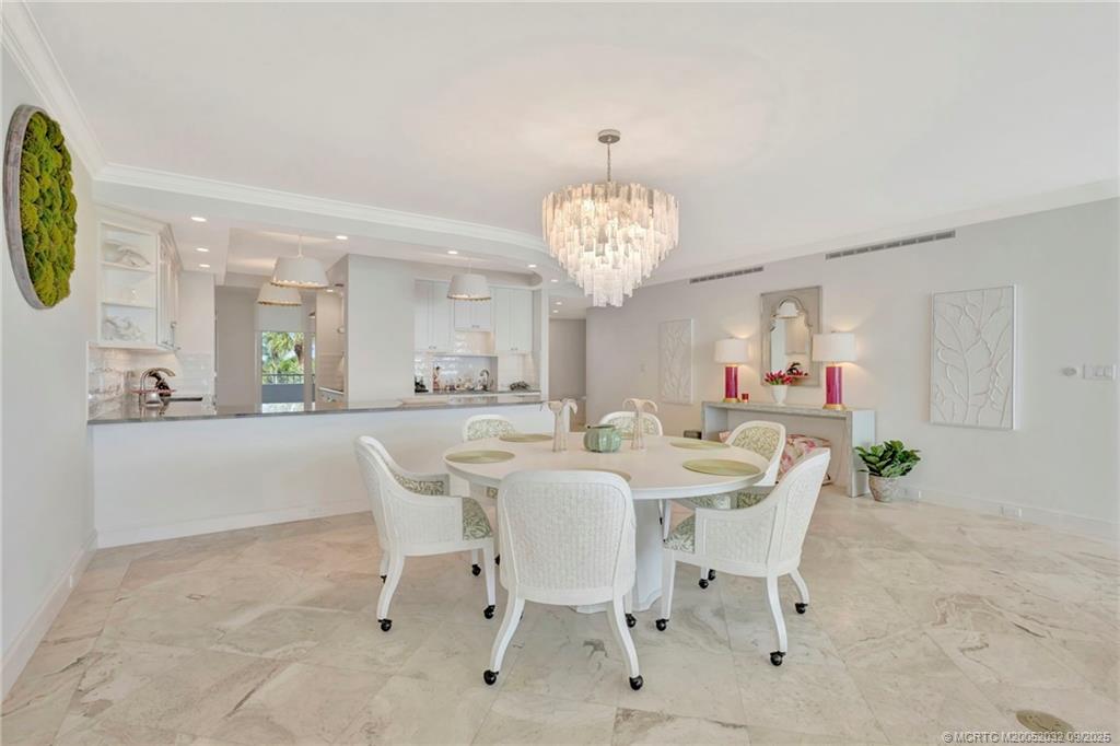 2001 Southeast Sailfish Point Boulevard, Unit 303 Stuart, FL 34996 - Photo 16 of 63 a view of a dining room with furniture and chandelier