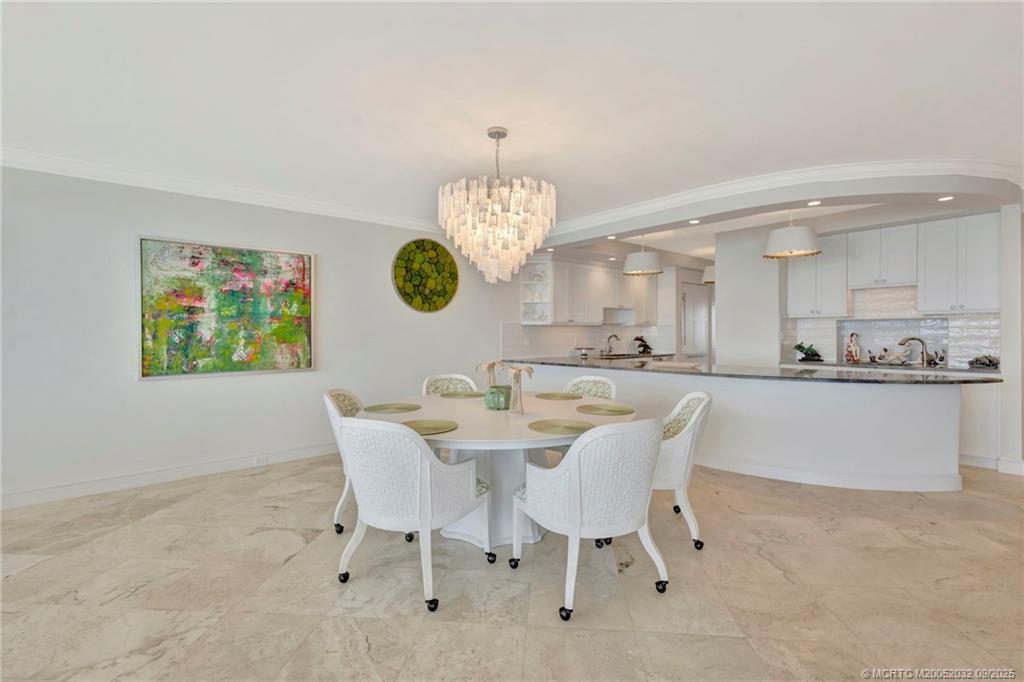 2001 Southeast Sailfish Point Boulevard, Unit 303 Stuart, FL 34996 - Photo 17 of 63 a view of a dining room and a chandelier