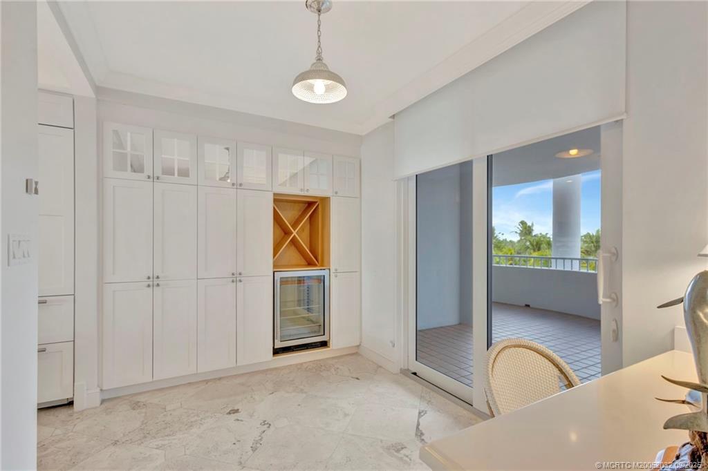 2001 Southeast Sailfish Point Boulevard, Unit 303 Stuart, FL 34996 - Photo 24 of 63 Pantry and storage plus wine cooler