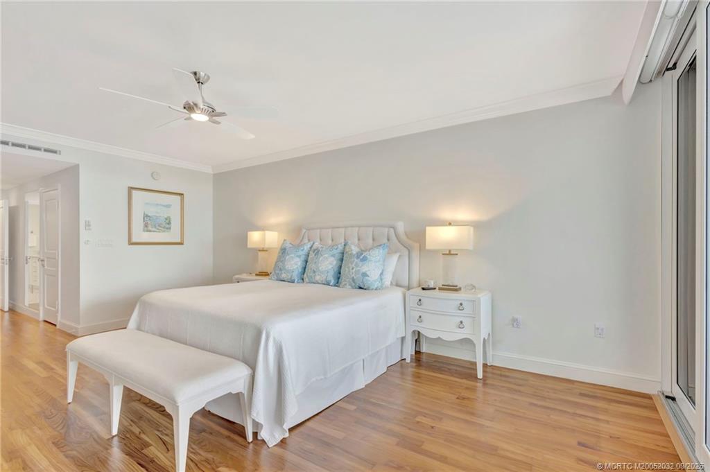 2001 Southeast Sailfish Point Boulevard, Unit 303 Stuart, FL 34996 - Photo 29 of 63 a bedroom with a bed and a lamp