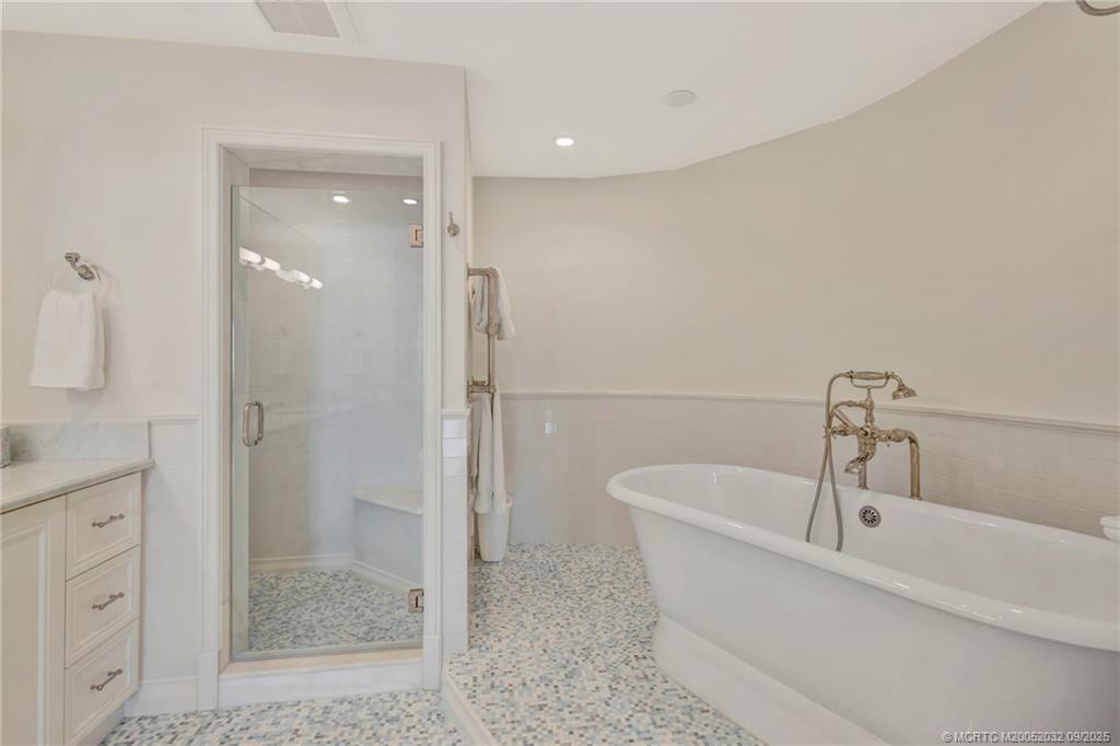 2001 Southeast Sailfish Point Boulevard, Unit 303 Stuart, FL 34996 - Photo 31 of 63 a bathroom with a bathtub and a shower