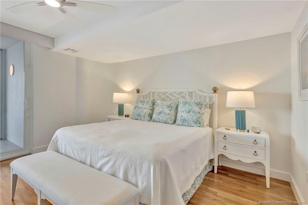 2001 Southeast Sailfish Point Boulevard, Unit 303 Stuart, FL 34996 - Photo 34 of 63 a bedroom with a bed and a lamp