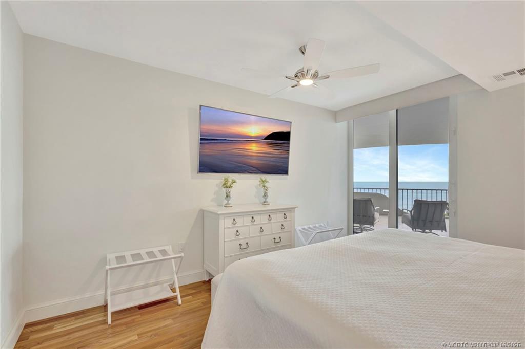 2001 Southeast Sailfish Point Boulevard, Unit 303 Stuart, FL 34996 - Photo 35 of 63 a bedroom with a bed and a flat screen tv