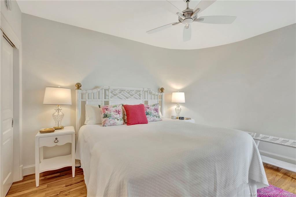 2001 Southeast Sailfish Point Boulevard, Unit 303 Stuart, FL 34996 - Photo 38 of 63 a bedroom with a bed and a chandelier