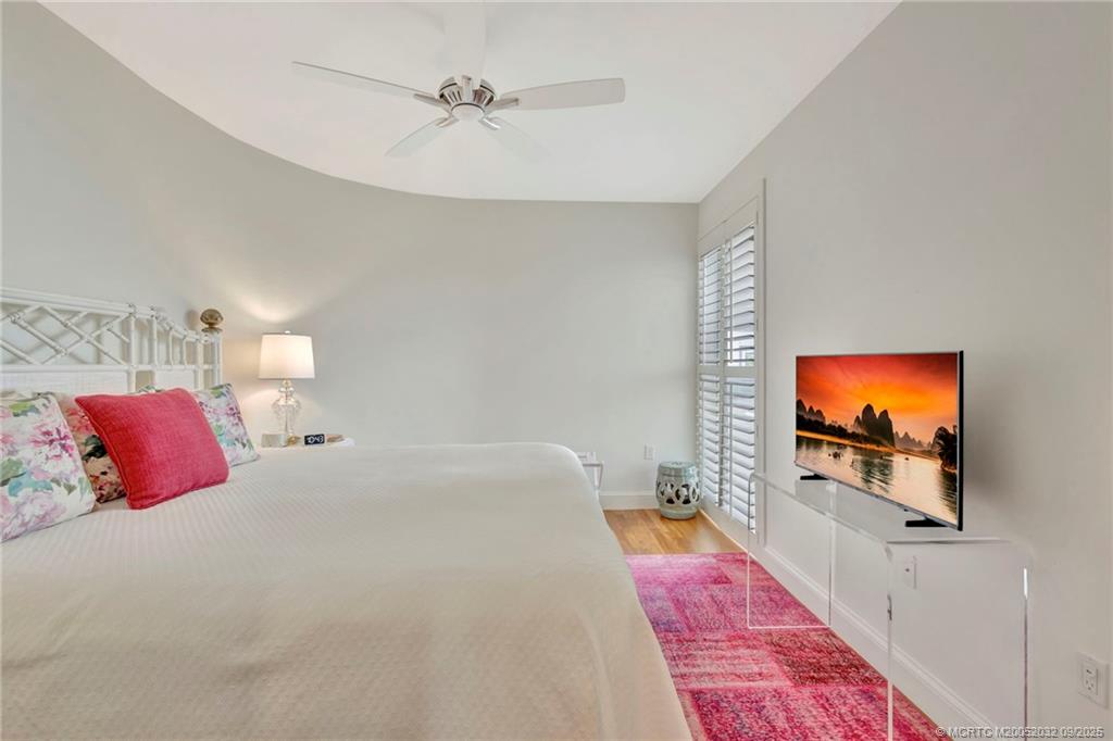 2001 Southeast Sailfish Point Boulevard, Unit 303 Stuart, FL 34996 - Photo 39 of 63 a bedroom with a bed and a flat screen tv