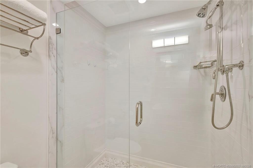 2001 Southeast Sailfish Point Boulevard, Unit 303 Stuart, FL 34996 - Photo 41 of 63 a bathroom with a shower