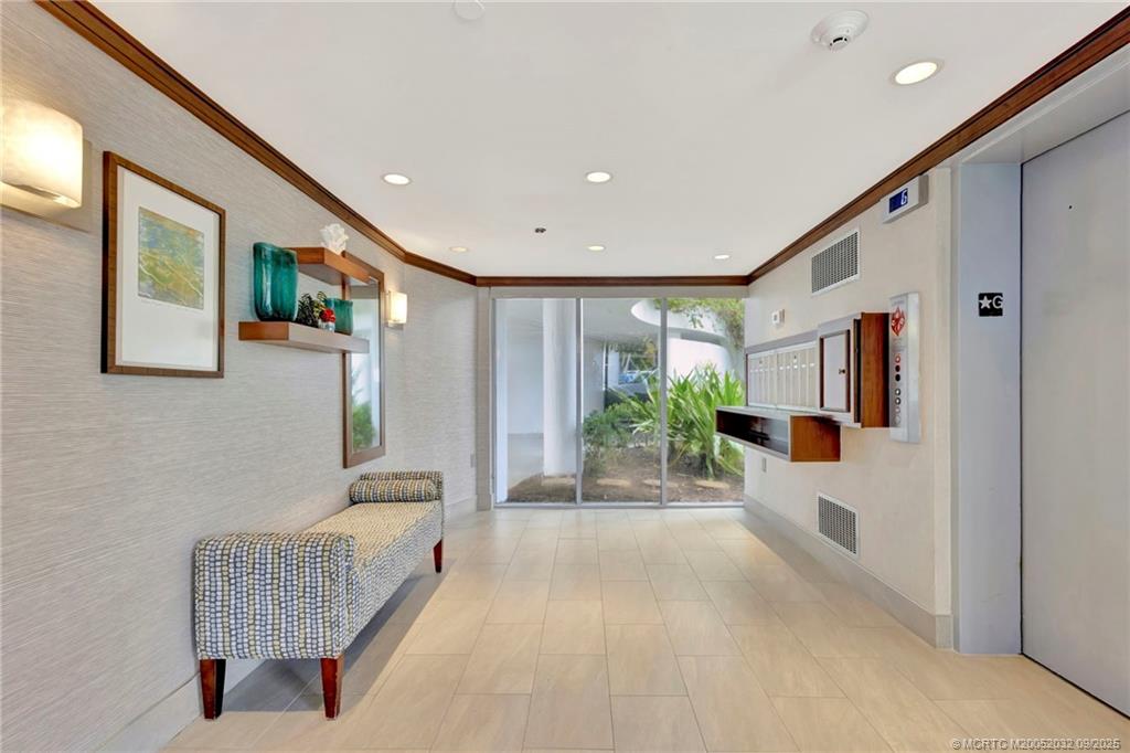2001 Southeast Sailfish Point Boulevard, Unit 303 Stuart, FL 34996 - Photo 43 of 63 a hallway with furniture and a couch