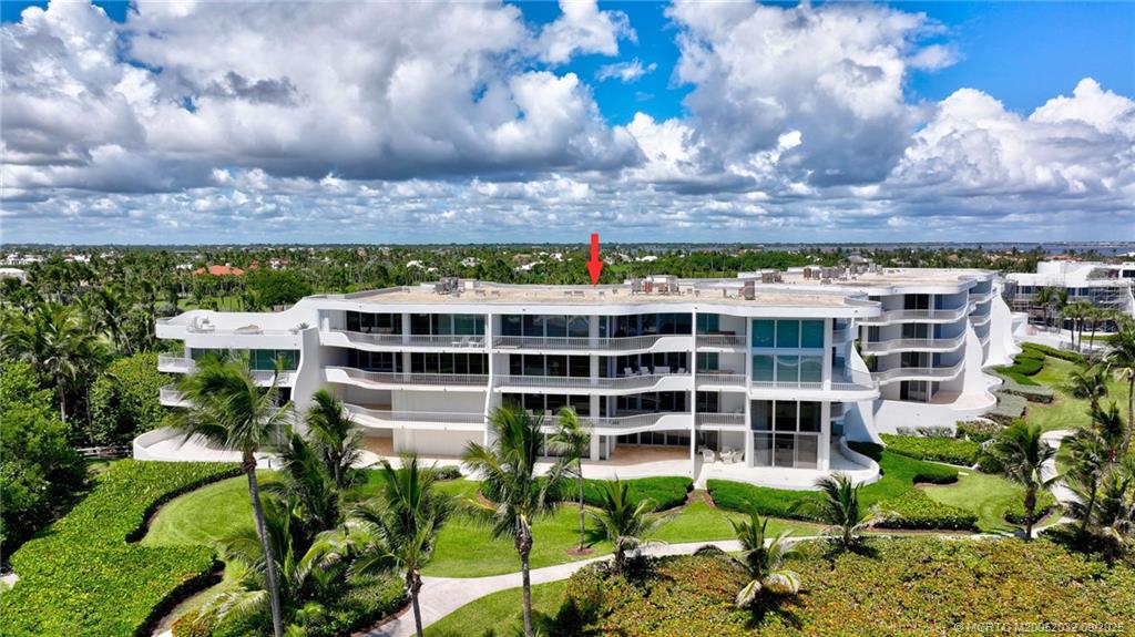 2001 Southeast Sailfish Point Boulevard, Unit 303 Stuart, FL 34996 - Photo 44 of 63 a view of a building with a garden
