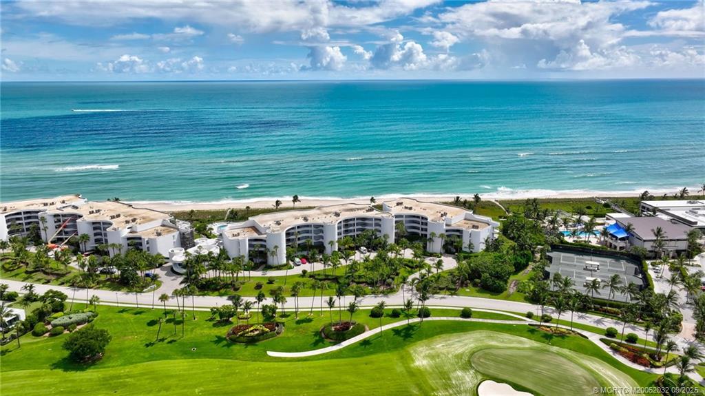 2001 Southeast Sailfish Point Boulevard, Unit 303 Stuart, FL 34996 - Photo 46 of 63 a view of yard with swimming pool and outdoor seating