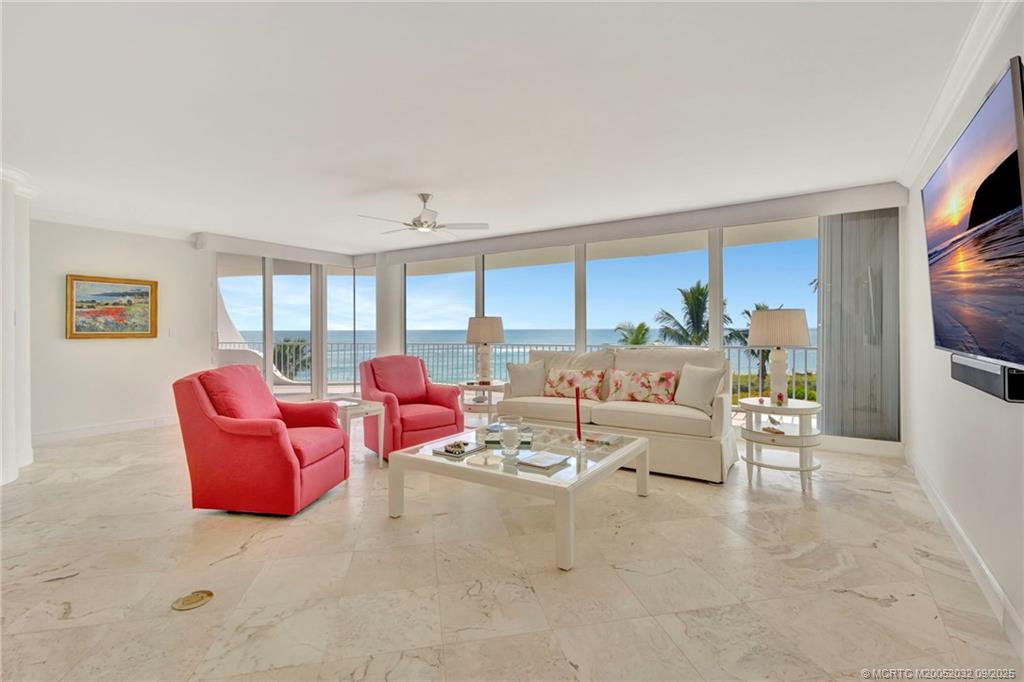 2001 Southeast Sailfish Point Boulevard, Unit 303 Stuart, FL 34996 - Photo 5 of 63 a living room with furniture and a flat screen tv