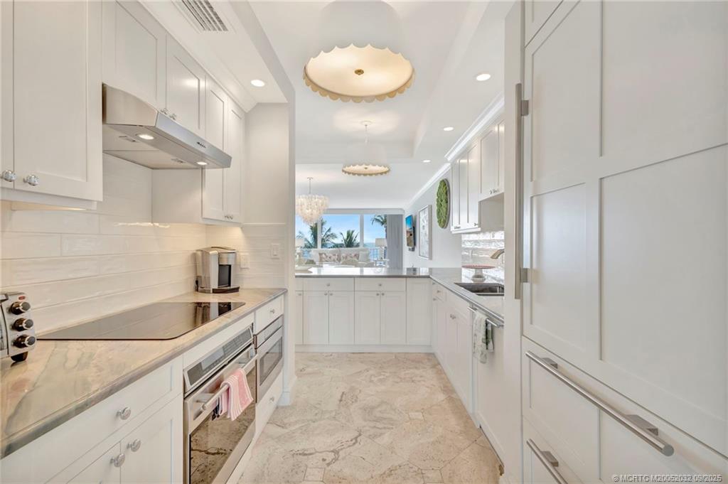 2001 Southeast Sailfish Point Boulevard, Unit 303 Stuart, FL 34996 - Photo 10 of 63 a kitchen with a sink cabinets and window
