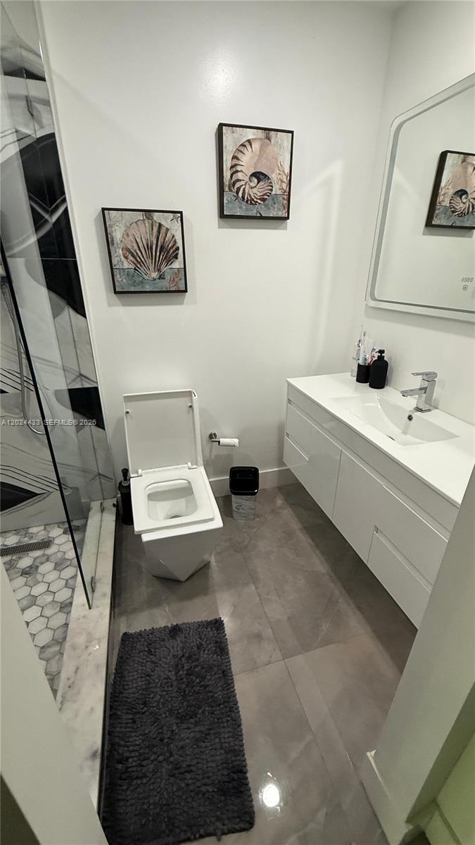 13675 Southwest 62nd Street, Unit 2023 Miami, FL 33183 - Photo 11 of 22 a bathroom with a sink and a mirror