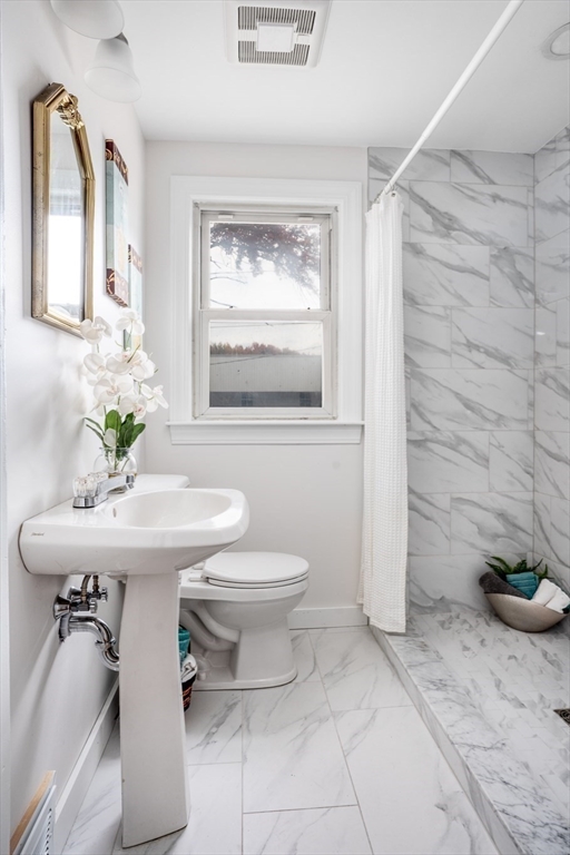 142 Amherst Street Ludlow, MA 01056 - Photo 16 of 34 a bathroom with a sink a toilet and mirror