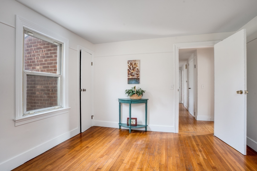 142 Amherst Street Ludlow, MA 01056 - Photo 20 of 34 a view of an empty room with wooden floor and a window