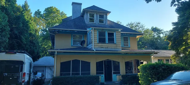 a view of a wooden house with a small yard