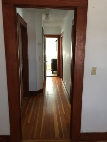 a view of a hallway view with wooden floor and staircase