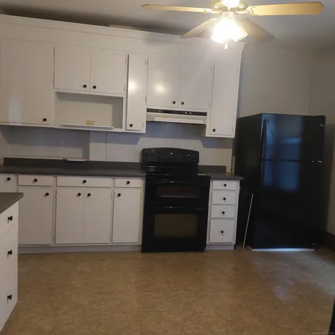 a kitchen with stainless steel appliances granite countertop a refrigerator and a stove
