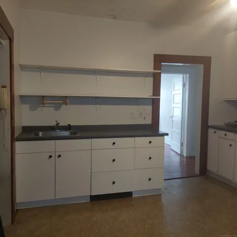 a living room with white cabinets and a fireplace