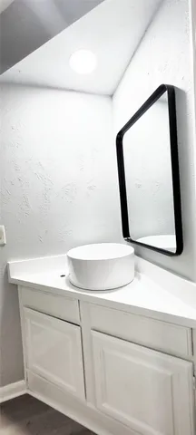 a bathroom with a sink and mirror