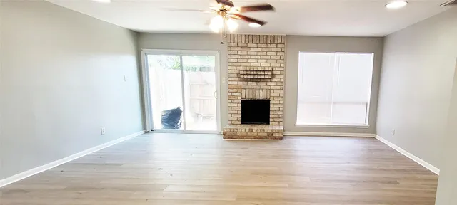 a view of fireplace with wooden floor and a window