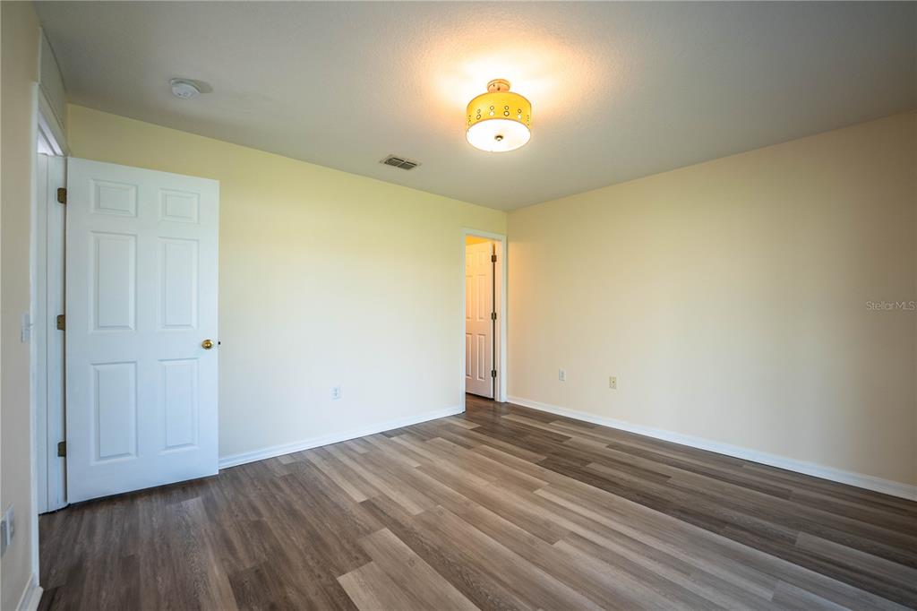 241 Grove Branch Road Winter Haven, FL 33880 - Photo 15 of 31 an empty room with wooden floor and windows