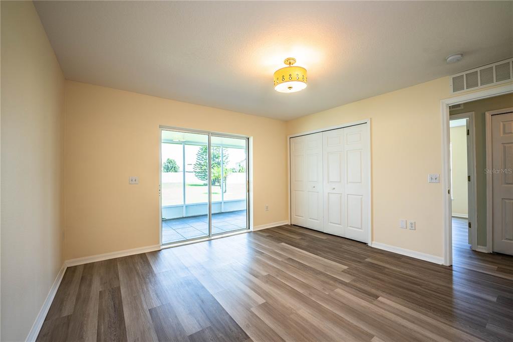 241 Grove Branch Road Winter Haven, FL 33880 - Photo 16 of 31 an empty room with wooden floor and windows