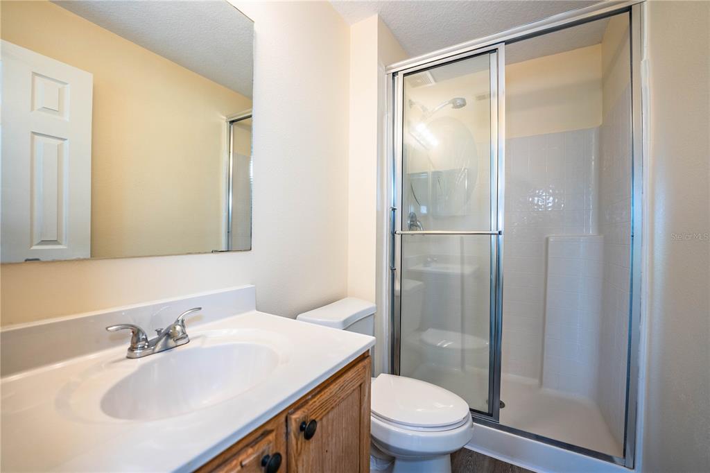 241 Grove Branch Road Winter Haven, FL 33880 - Photo 17 of 31 a bathroom with a shower sink vanity mirror and toilet