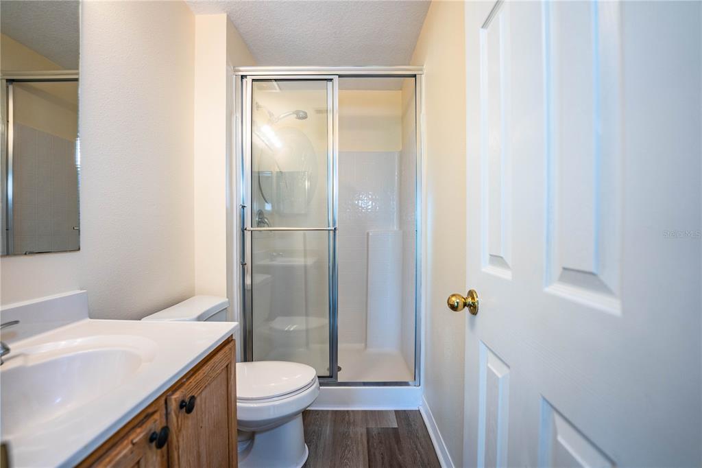 241 Grove Branch Road Winter Haven, FL 33880 - Photo 18 of 31 a bathroom with a granite countertop toilet a sink and a mirror