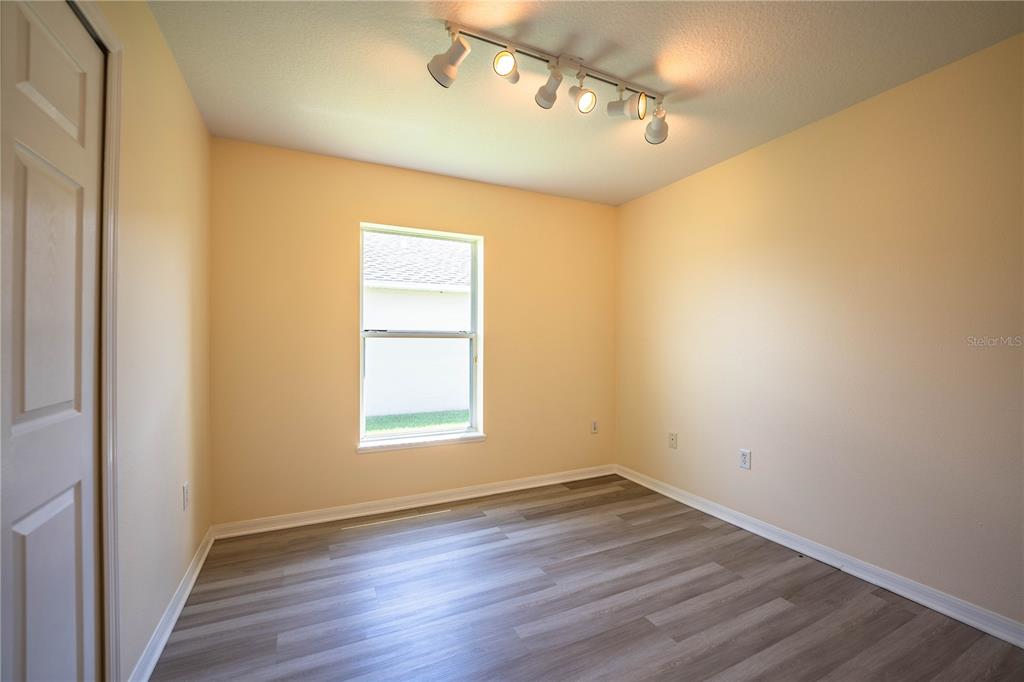 241 Grove Branch Road Winter Haven, FL 33880 - Photo 19 of 31 an empty room with wooden floor and windows