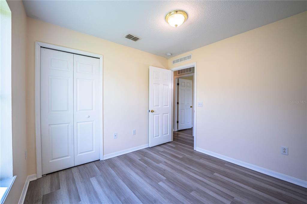 241 Grove Branch Road Winter Haven, FL 33880 - Photo 22 of 31 an empty room with wooden floor and closet
