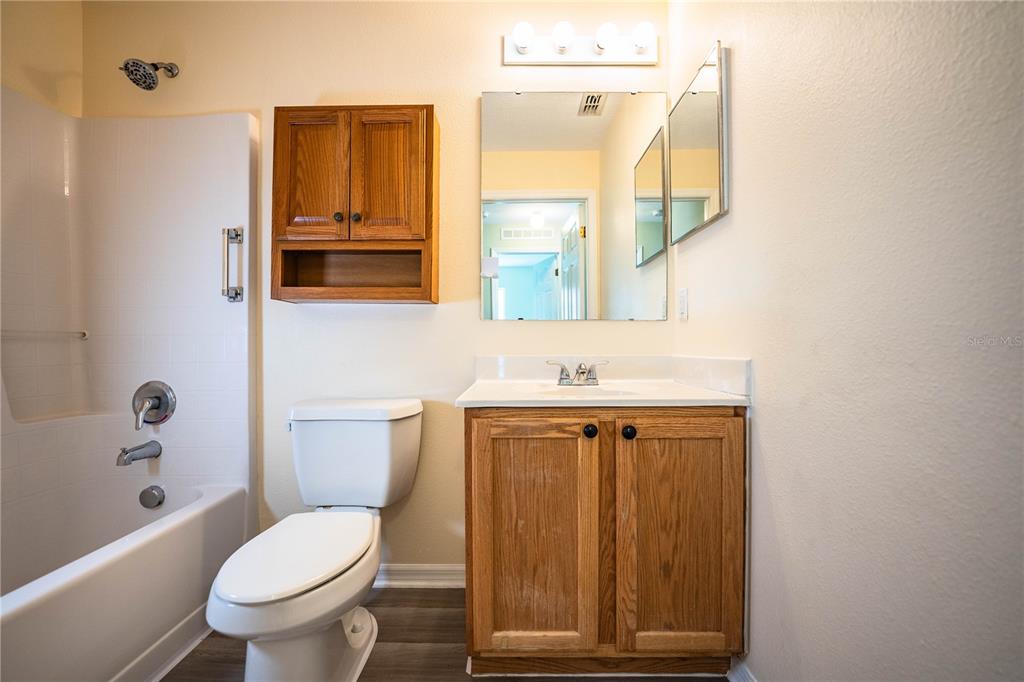 241 Grove Branch Road Winter Haven, FL 33880 - Photo 24 of 31 a bathroom with a toilet a sink and a mirror