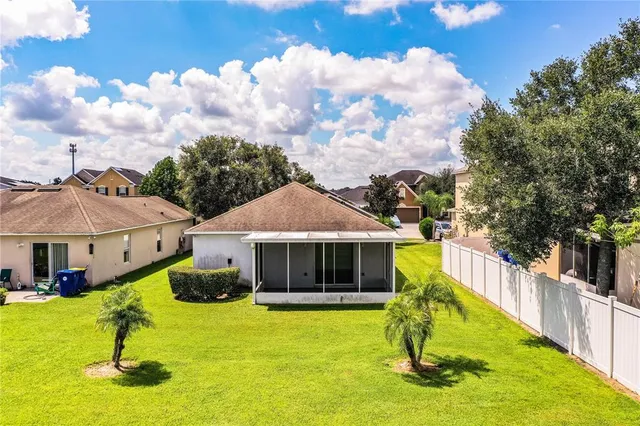 a view of a house with swimming pool and a yard