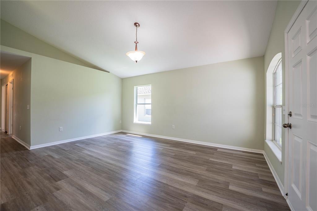 241 Grove Branch Road Winter Haven, FL 33880 - Photo 5 of 31 wooden floor in an empty room with a window