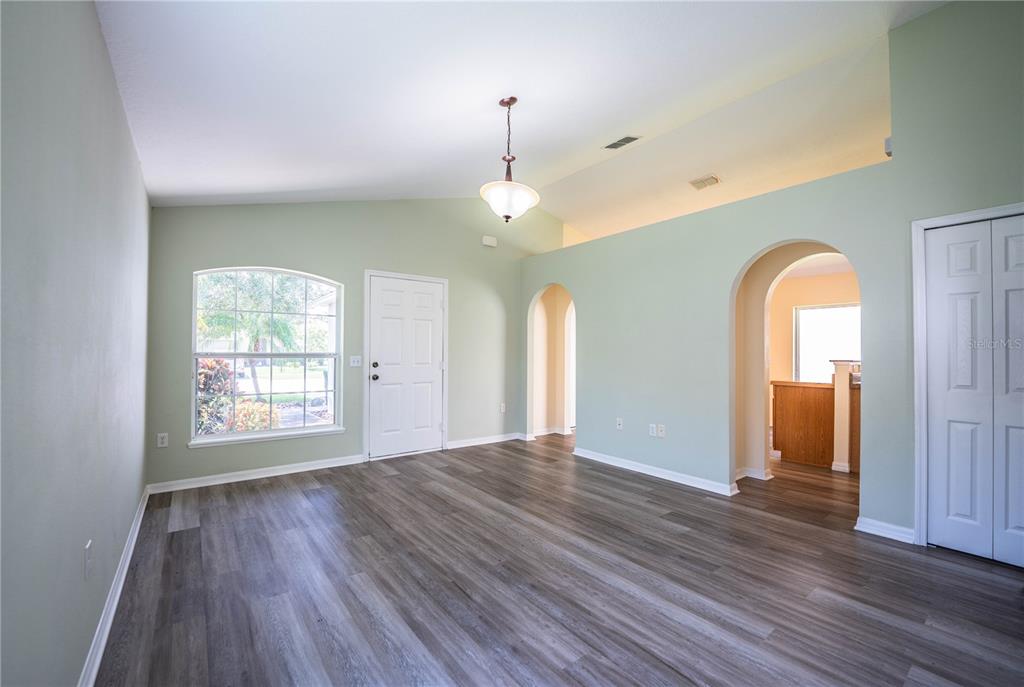 241 Grove Branch Road Winter Haven, FL 33880 - Photo 7 of 31 a view of empty room with wooden floor and fan