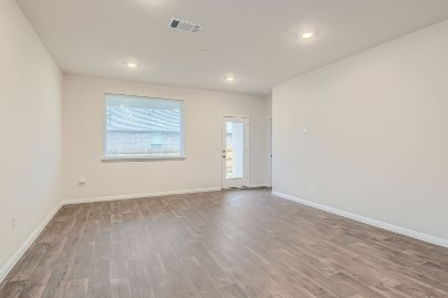 709 Iron Brg Road Georgetown, TX 78626 - Photo 6 of 11 Bright, airy room with elegant wood flooring and a convenient outdoor access point.