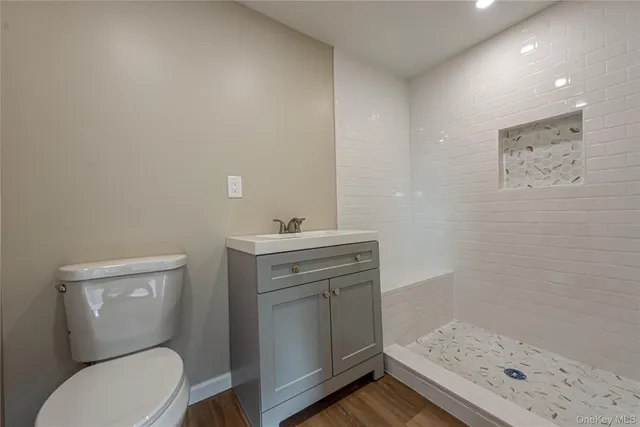 a bathroom with a toilet sink and mirror