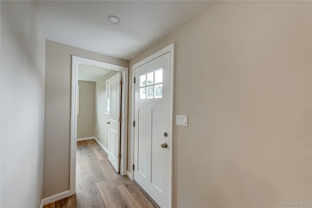 a view of a hallway with wooden floor