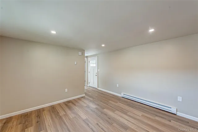 a view of room with wooden floor